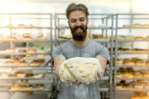 Man in kitchen preparing donuts photo