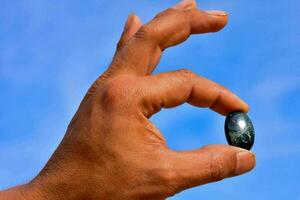 Hand holding a semi precious stone photo