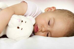 Baby sleep with toy photo