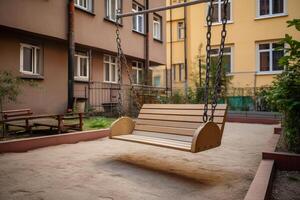 wooden swing in the yard. the shop is hanging on a chain. photo