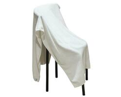 Used white towel laying on chair isolated on white background with clipping path photo