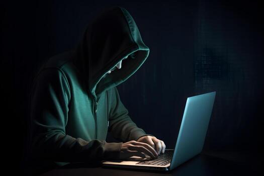 Internet hacker sitting at personal computer laptop tablet photo