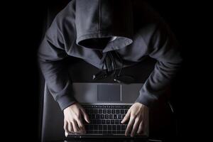 Internet hacker sitting at personal computer laptop tablet photo
