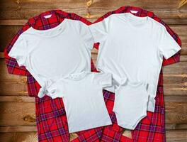 Blank white t-shirts for the whole family on the background of bright pajamas photo
