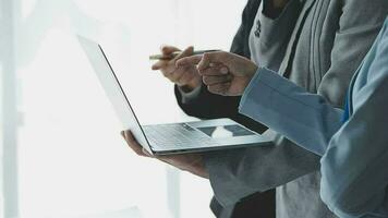 Financial analysts analyze business financial reports on a digital tablet planning investment project during a discussion at a meeting of corporate showing the results of their successful teamwork. video