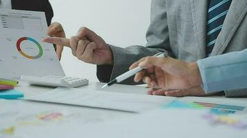 Financial analysts analyze business financial reports on a digital tablet planning investment project during a discussion at a meeting of corporate showing the results of their successful teamwork. video
