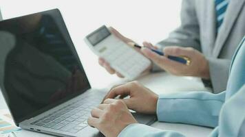 Financial analysts analyze business financial reports on a digital tablet planning investment project during a discussion at a meeting of corporate showing the results of their successful teamwork. video