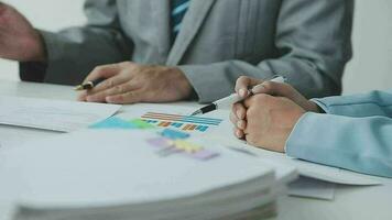 Financial analysts analyze business financial reports on a digital tablet planning investment project during a discussion at a meeting of corporate showing the results of their successful teamwork. video