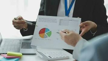 Financial analysts analyze business financial reports on a digital tablet planning investment project during a discussion at a meeting of corporate showing the results of their successful teamwork. video