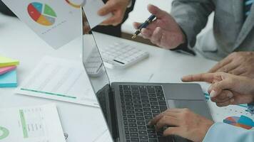 Financial analysts analyze business financial reports on a digital tablet planning investment project during a discussion at a meeting of corporate showing the results of their successful teamwork. video