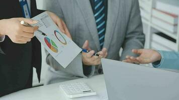 Financial analysts analyze business financial reports on a digital tablet planning investment project during a discussion at a meeting of corporate showing the results of their successful teamwork. video