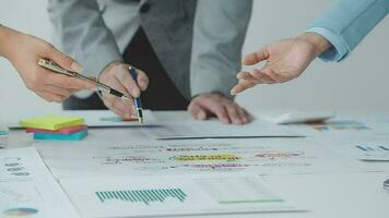 Financial analysts analyze business financial reports on a digital tablet planning investment project during a discussion at a meeting of corporate showing the results of their successful teamwork. video