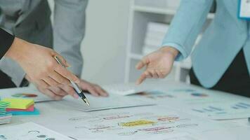 Financial analysts analyze business financial reports on a digital tablet planning investment project during a discussion at a meeting of corporate showing the results of their successful teamwork. video