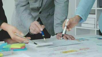 Financial analysts analyze business financial reports on a digital tablet planning investment project during a discussion at a meeting of corporate showing the results of their successful teamwork. video