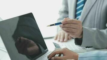 Financial analysts analyze business financial reports on a digital tablet planning investment project during a discussion at a meeting of corporate showing the results of their successful teamwork. video