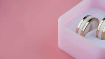 wedding ring in a box o isolated on pink video