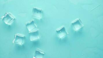 close up of many ice cubes on blue background video