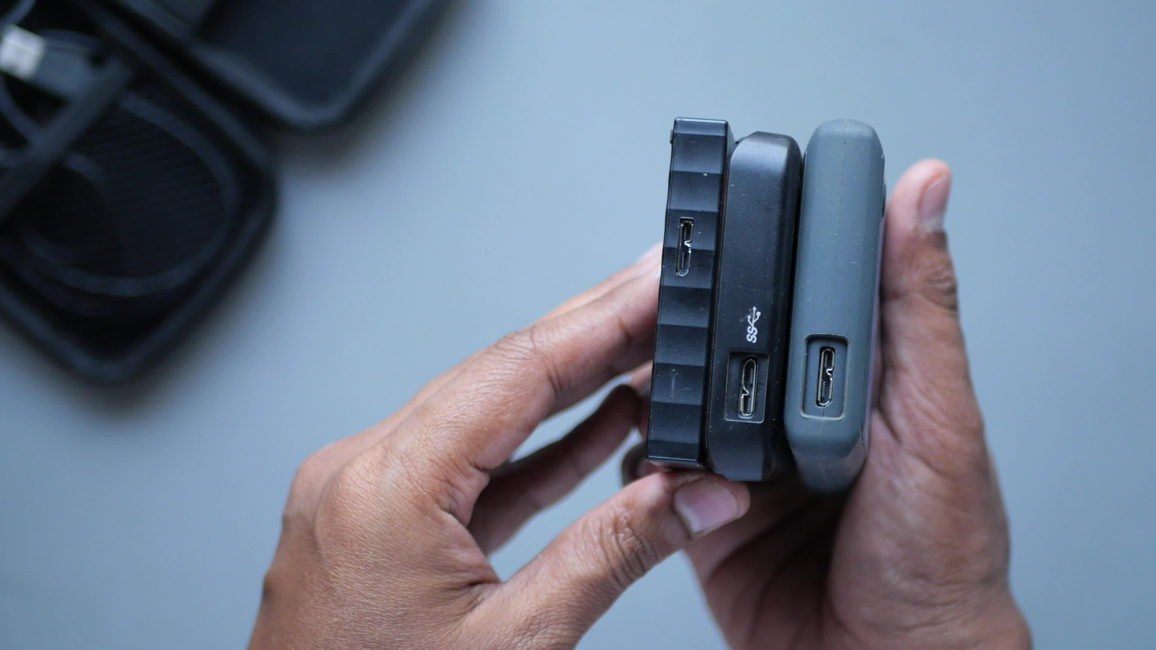 stack of external hard drives on hand . 23286987 Stock Video at Vecteezy