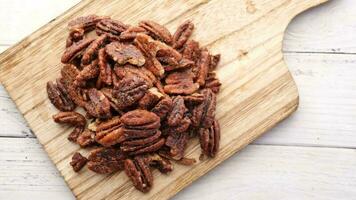 Tasty pecan-nut on a wooden board on white color table video