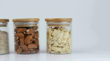 almond powder and almond in a jar on table, video