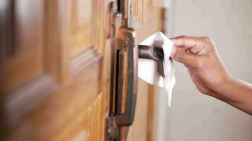 Cleaning door handles with an antiseptic, close up video