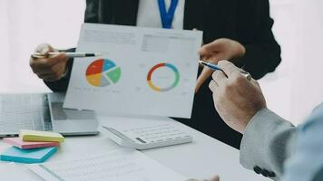 Financial analysts analyze business financial reports on a digital tablet planning investment project during a discussion at a meeting of corporate showing the results of their successful teamwork. video