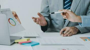 Financial analysts analyze business financial reports on a digital tablet planning investment project during a discussion at a meeting of corporate showing the results of their successful teamwork. video