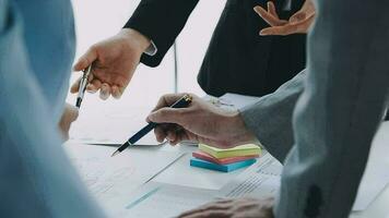 Financial analysts analyze business financial reports on a digital tablet planning investment project during a discussion at a meeting of corporate showing the results of their successful teamwork. video