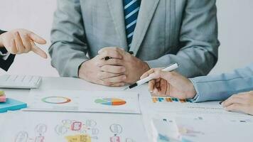 Financial analysts analyze business financial reports on a digital tablet planning investment project during a discussion at a meeting of corporate showing the results of their successful teamwork. video