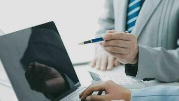 Financial analysts analyze business financial reports on a digital tablet planning investment project during a discussion at a meeting of corporate showing the results of their successful teamwork. video