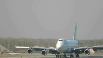 Cargo Boeing 747 brakes on the runway after landing. Jumbo jet drives and slows down video