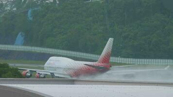 PHUKET, THAILAND DECEMBER 4, 2016 - Rossiya Boeing 747 take off from Phuket airport HKT. The jumbo jet picks up speed in the early morning. It is a plume of water spray on the runway. video