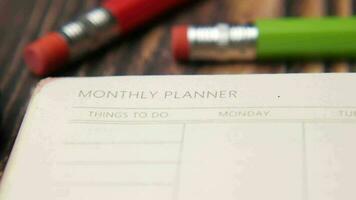 Close up of monthly planner and notepad on table video