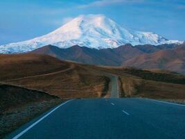 Moonlight on Elbrus mountain. Morning landscape with winding hig photo