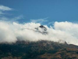 montaña en el blanco nubes místico paisaje con hermosa agudo rocas en bajo nubes hermosa montaña brumoso paisaje en abismo borde con agudo piedras foto