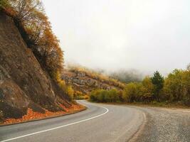 High Alpine road. Beautiful autumn high-mountain highway with dangerous twisting turns. photo