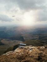 Beautiful mountain landscape with a table over a cliff. photo