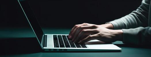 Hands of a person using a keyboard on a laptop. Dark aquamarine and gray color concept. photo