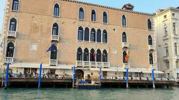 Venice By boat on the grand canal with buildings restaurants and gondolas video