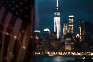 Photo of american flag in front of bokeh effect of cityscape in background.