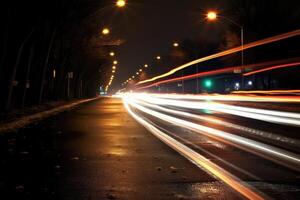 Photo of night city lights and traffic speeding by cars. Bokeh effect background.