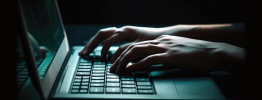 Hands of a person using a keyboard on a laptop. Dark aquamarine and gray color concept. photo