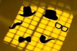 Happy Fathers Day sticker, black hat, bow tie, glasses and mustache, on yellow. Hipster objects. Father's Day is a holiday. Design Blank space for an inscription. Flat composition with greeting card. photo