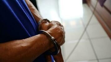 Man handcuffed hands. Prisoner or arrested. photo