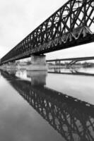 Bridge reflection in the river photo