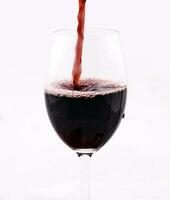 Wine splashing in glass photo