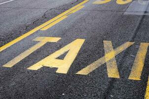 Taxi sign on the road photo