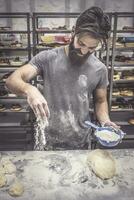 Man in kitchen preparing donuts photo