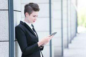 Modern business woman holding tablet photo