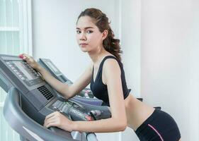 Running on treadmill in gym or fitness club photo